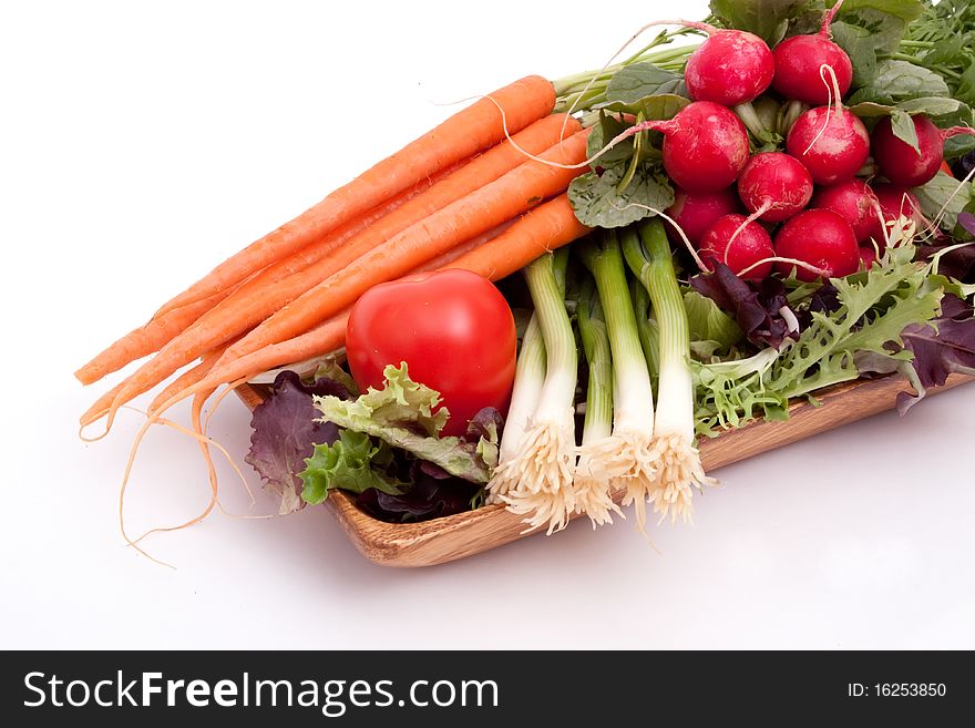 Fresh carrots, radishes, scallions, tomatoes and greens. Fresh carrots, radishes, scallions, tomatoes and greens