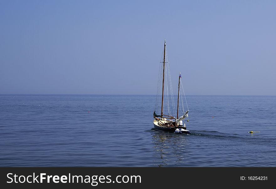 A two masted sailboat heading out to the open ocean