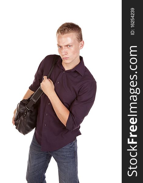 A young man with a serious expression on his face carring a duffel bag. A young man with a serious expression on his face carring a duffel bag.