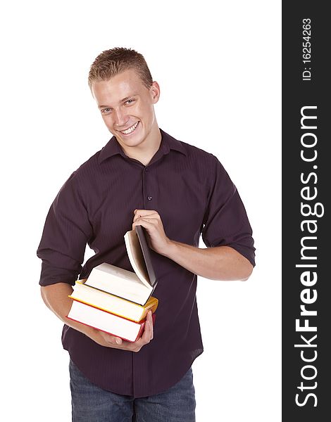 A young college student with a stack of books in his hands getting ready to read. A young college student with a stack of books in his hands getting ready to read.