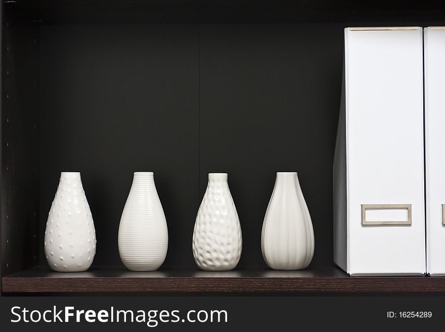 Wooden shelf with white vases. Wooden shelf with white vases