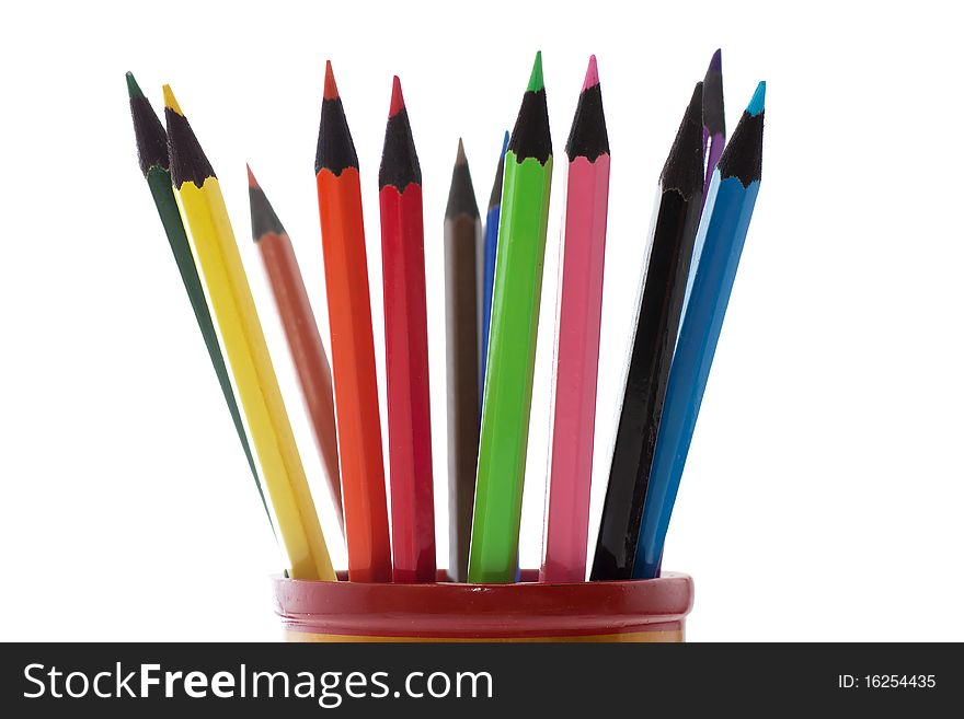 Colored pencils in a cup isolated over white background