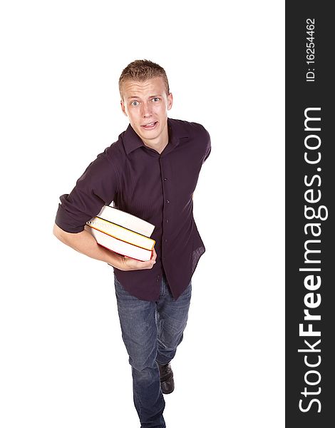 A college student carring around a pile of books with a scared expression on his face. A college student carring around a pile of books with a scared expression on his face.