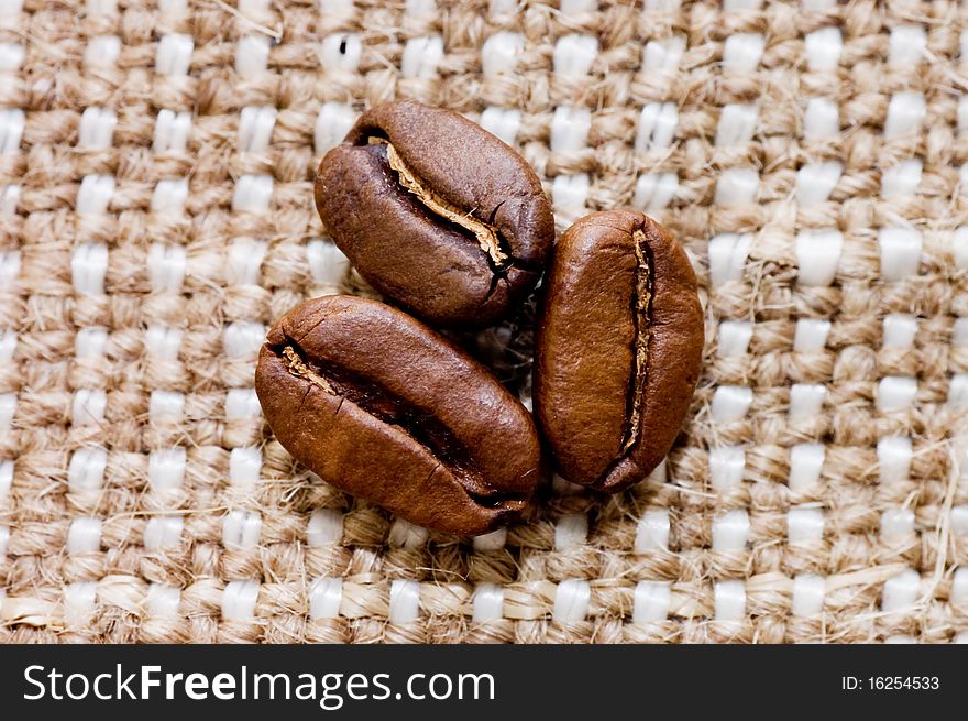 Brown coffee grains on a sacking macro