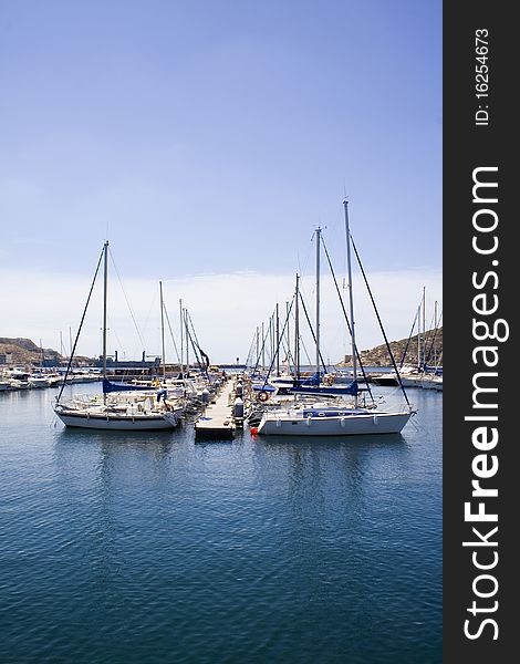 Small yachts moored on a pontoon in a Spanish harbour. Small yachts moored on a pontoon in a Spanish harbour.