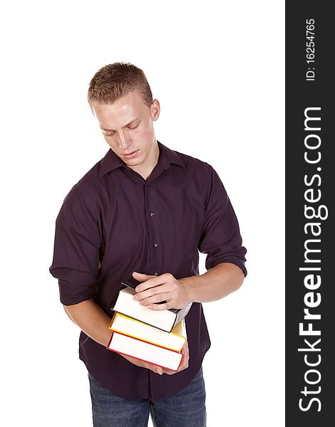 A young college student with a stack of books in his hands getting ready to read. A young college student with a stack of books in his hands getting ready to read.