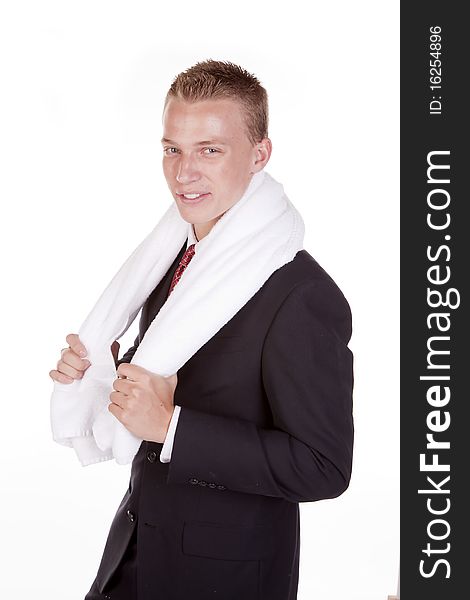 A young business man smiling with a towel on his shoulders. A young business man smiling with a towel on his shoulders.