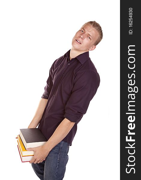 A young college student carring a handfull of books with a stressed out expression on his face. A young college student carring a handfull of books with a stressed out expression on his face.