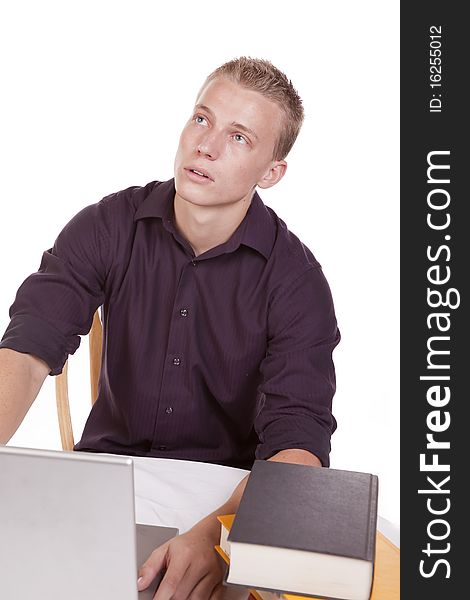 A young man tired of studing and working on his computer. A young man tired of studing and working on his computer.