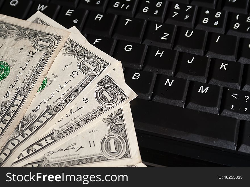 One dollar banknotes on laptop keyboard. One dollar banknotes on laptop keyboard.