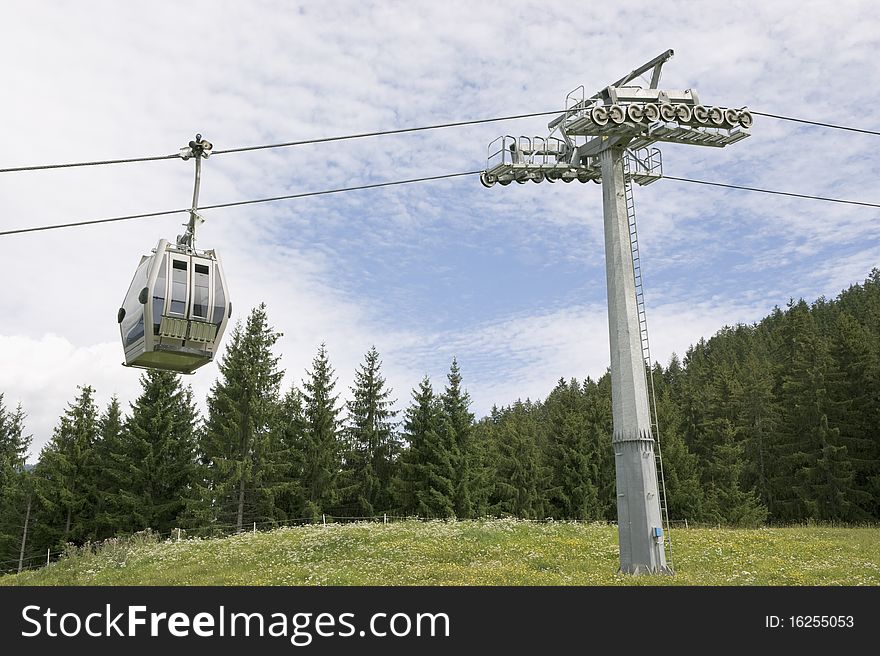 Cable car on a cableway in Italian Alps on a cloudy, summer day. Cable car on a cableway in Italian Alps on a cloudy, summer day.