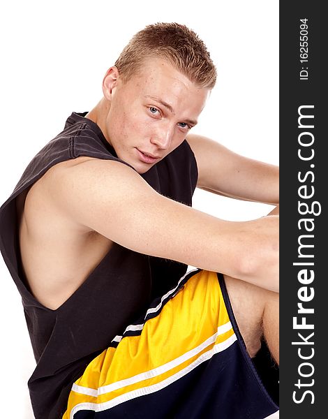 A young man taking a few minutes to rest from exercising. A young man taking a few minutes to rest from exercising.