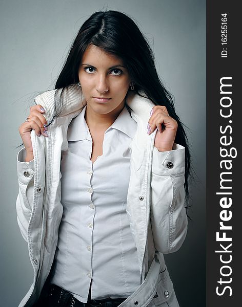 Portrait of a beautiful fashion female model with a white jacket. Portrait of a beautiful fashion female model with a white jacket