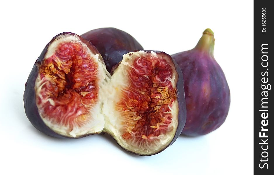 Three ripe figs on a white background close up