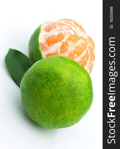 Green tangerines close up on a white background. Green tangerines close up on a white background
