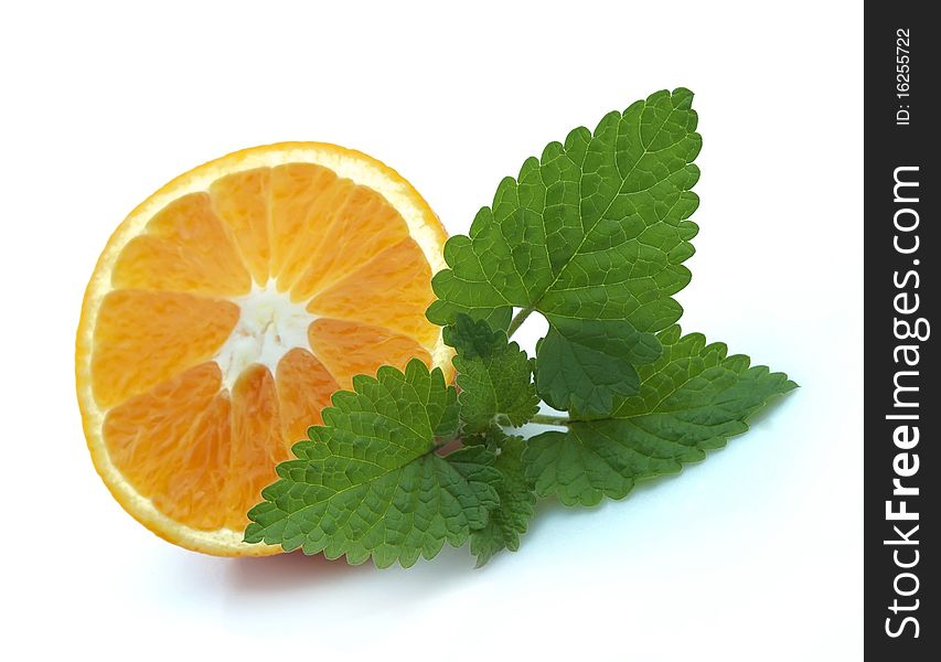 Ripe orange and branch of fragrant mint. Ripe orange and branch of fragrant mint