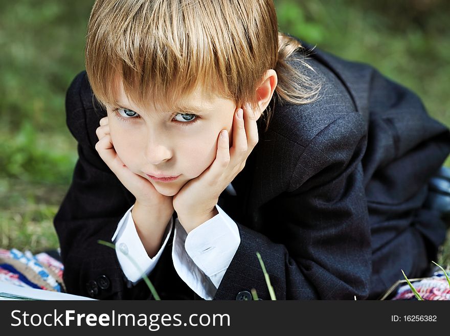 Shot of a little boy having a rest outdoor. Shot of a little boy having a rest outdoor.