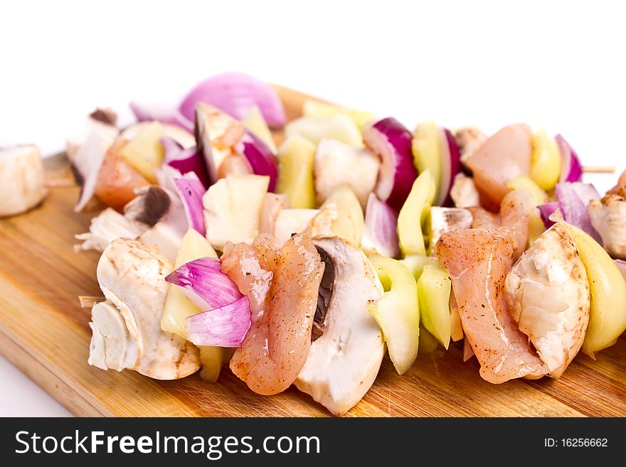 Raw chicken and vegetables skewers. Raw chicken and vegetables skewers