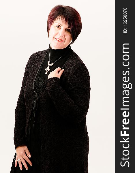 Beautiful attractive fuller figure mature short haired woman with hand on shoulder dressed in black knitted jacket. Beautiful attractive fuller figure mature short haired woman with hand on shoulder dressed in black knitted jacket