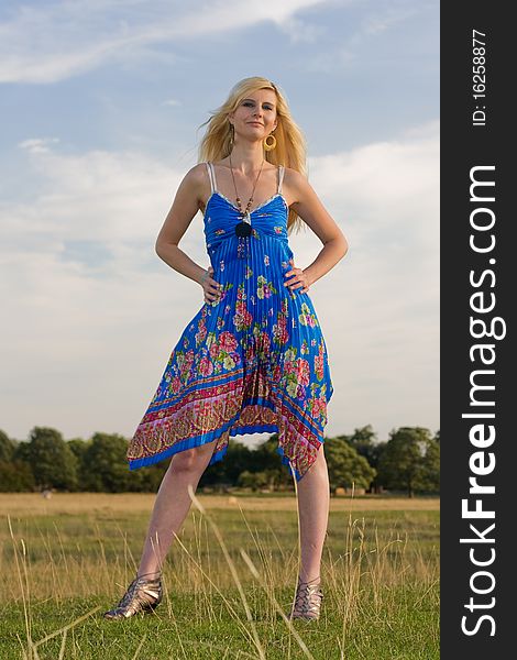 A young woman standing in a field.