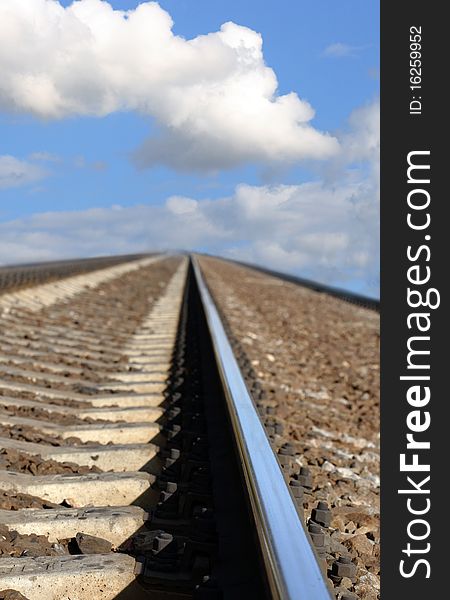 Closeup of railroad track on background with blue sky. Closeup of railroad track on background with blue sky