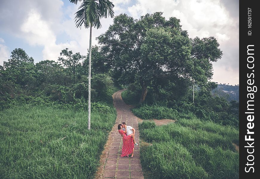 Young couple posing on the road in the jungle of Bali island.