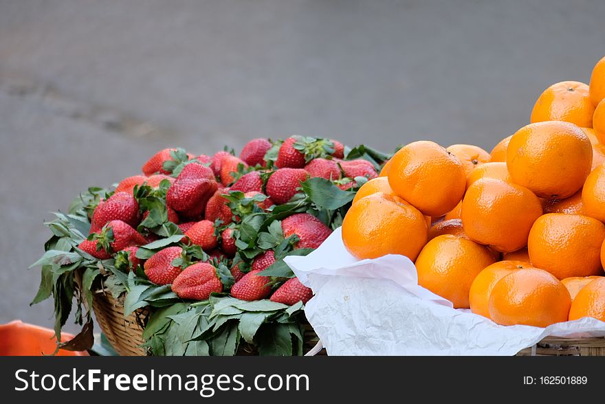 Strawberries and Oranges for Sale in Baskets