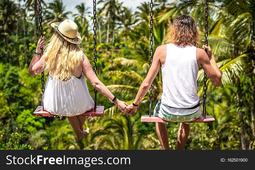 Couple Swinging In The Jungle