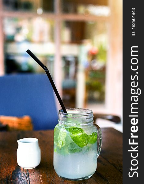 Fresh drink lemonade mojito on wooden table. Mojitos with mint leaves, lime and ice, outdoor. Bali island. Fresh drink lemonade mojito on wooden table. Mojitos with mint leaves, lime and ice, outdoor. Bali island.