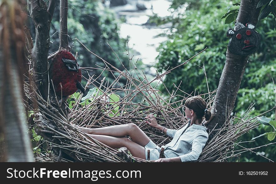 Young woman relaxing in the jungle of Bali island.
