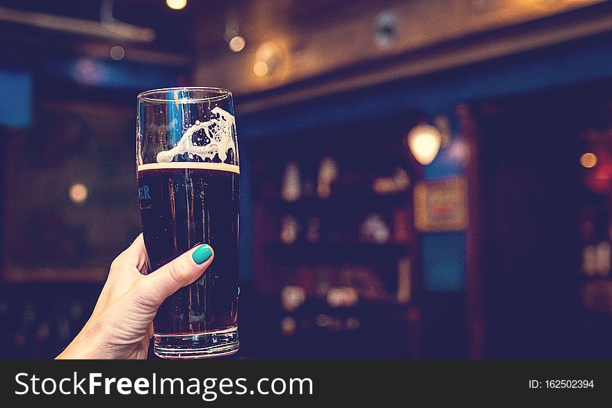 Woman hand with glass of beer