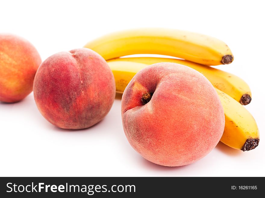 Peaches and bananas isolated on white - vegeterian healthy food