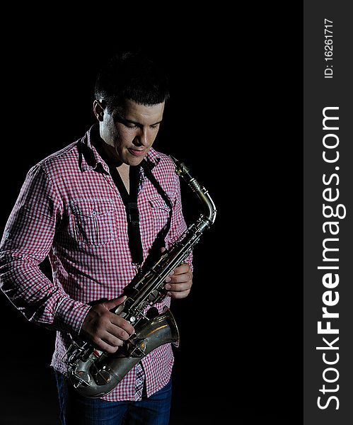 Young Handsome Man Playing Music On Saxophone