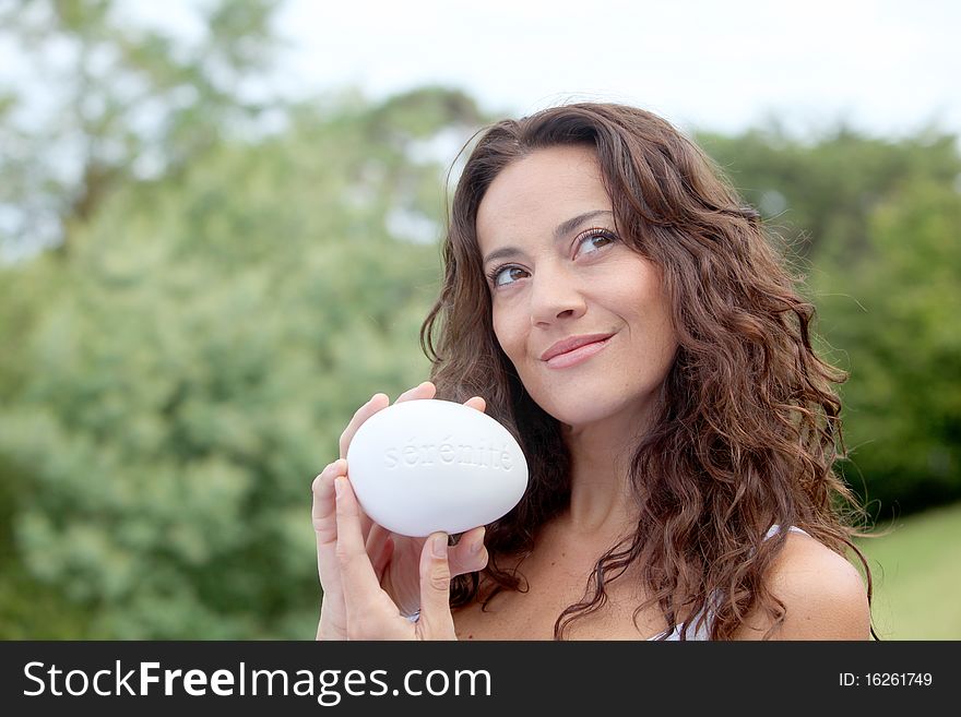 Closeup of beautiful woman holding stone. Closeup of beautiful woman holding stone