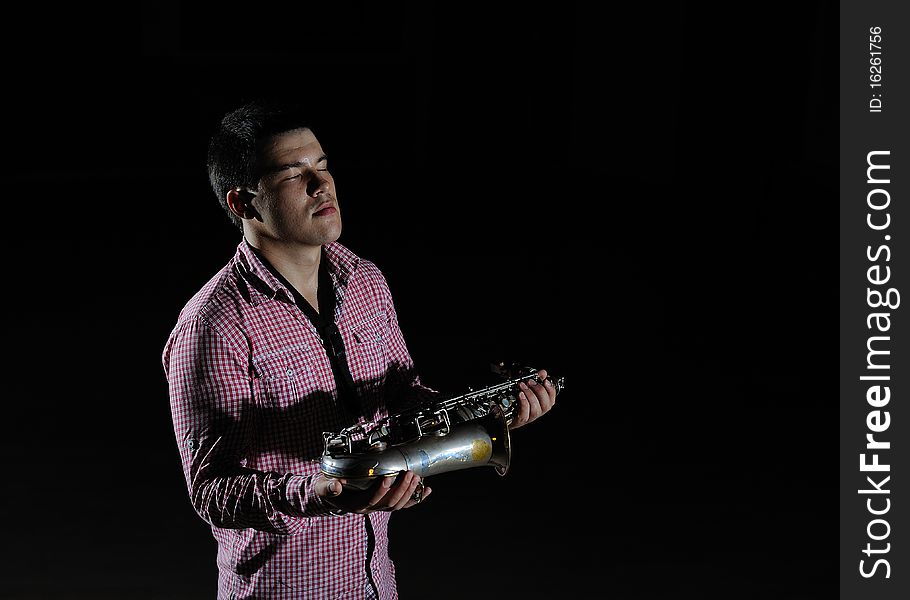 Young Handsome Man Playing Music On Saxophone