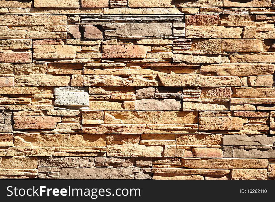 Part of a wall built of bricks of different natural