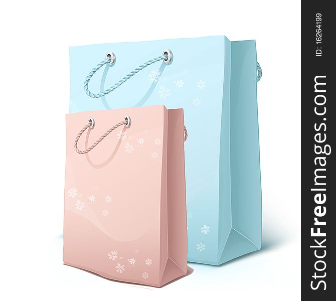 Pink and blue shopping bags with snowflakes isolated on white.