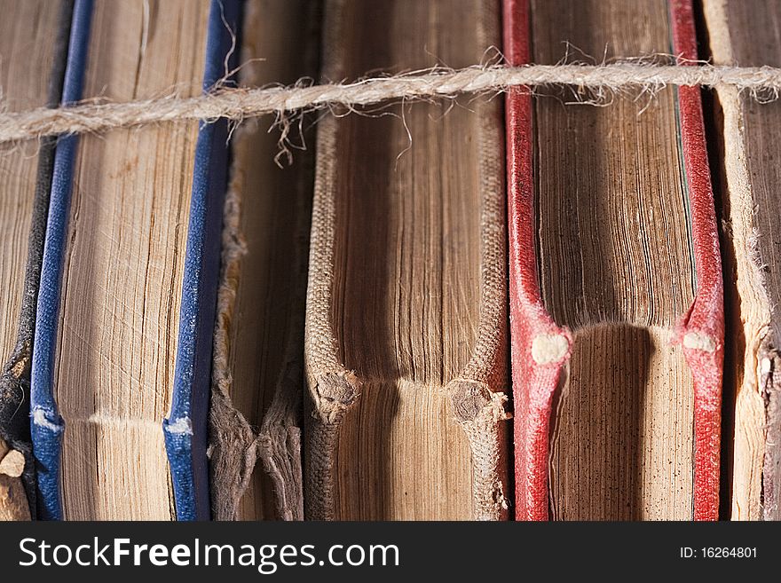 Archival books in a book-depository are tied up by a cord. Archival books in a book-depository are tied up by a cord.