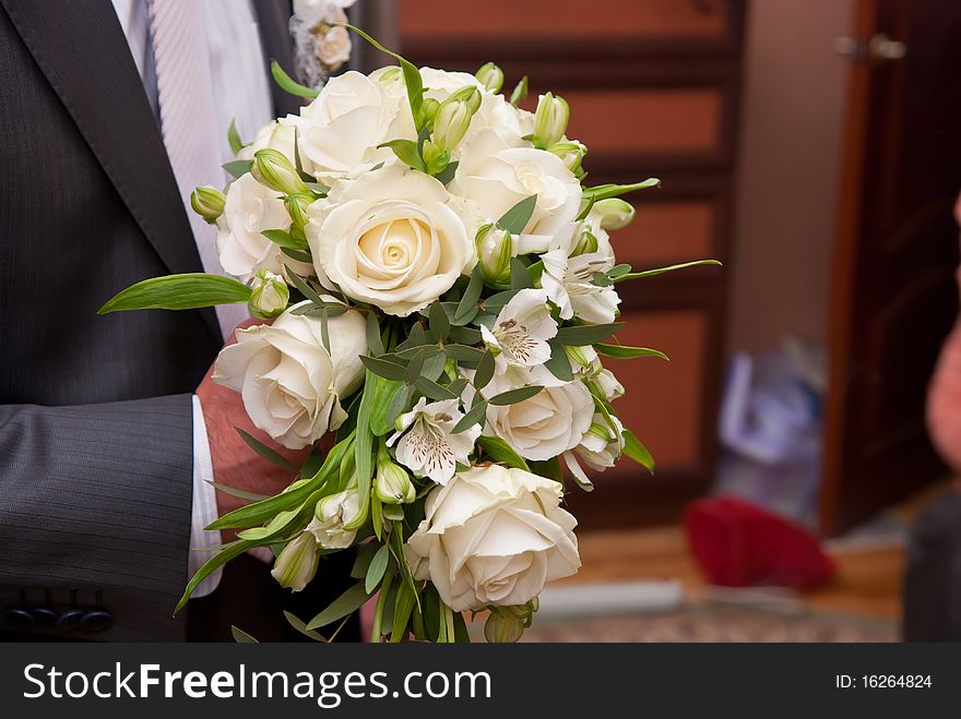 Beautiful bouquet from white roses in man's hand. Beautiful bouquet from white roses in man's hand