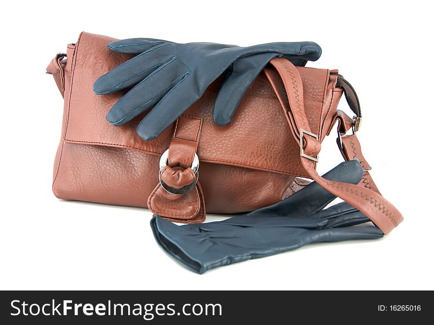 Studio shot of the brown leather purse and dark leather gloves. Studio shot of the brown leather purse and dark leather gloves