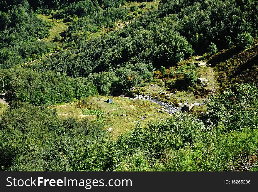 Small camping in the mountains near the forest and river