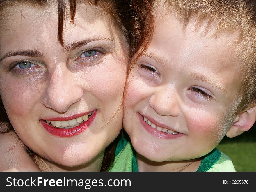 Face of the mother and son close up look at the camera smiling