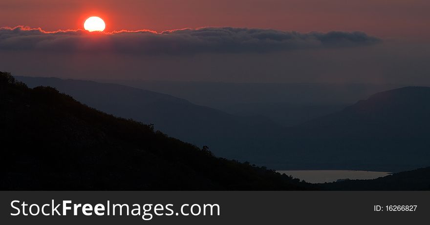 Mountain landscape with view of pink sunset