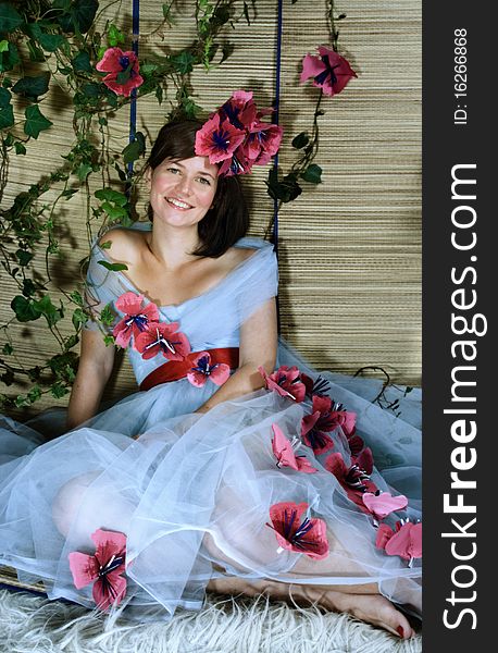 Young beautiful brunette with green eyes smiling in garden. Young beautiful brunette with green eyes smiling in garden