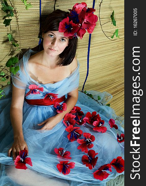 Portrait of a young woman with green eyes posing in a studio wearing a beautiful gown. Portrait of a young woman with green eyes posing in a studio wearing a beautiful gown