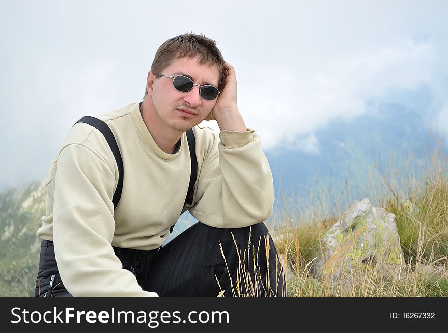 A Young Man Sits On A Hilltop