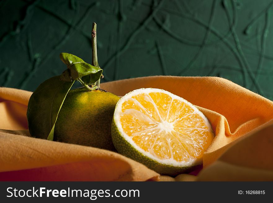 Two Green Miyagawa Mandarins with Orange Napkin