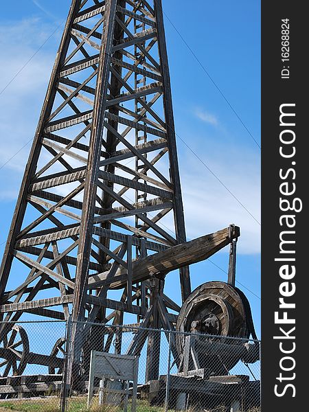 Wooden vintage oil rig in the field. Wooden vintage oil rig in the field.