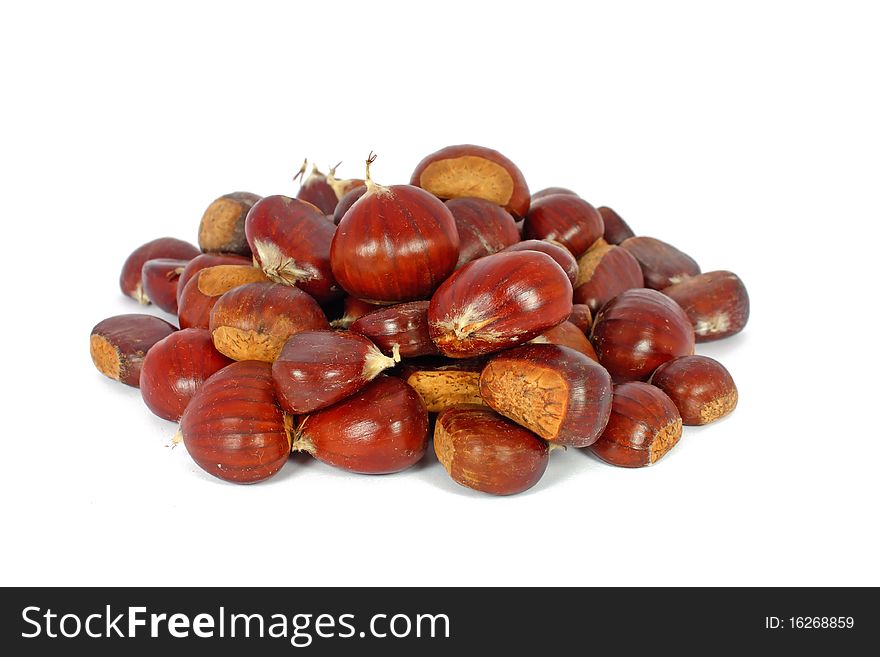 Heap of raw eatable chestnuts isolated on white