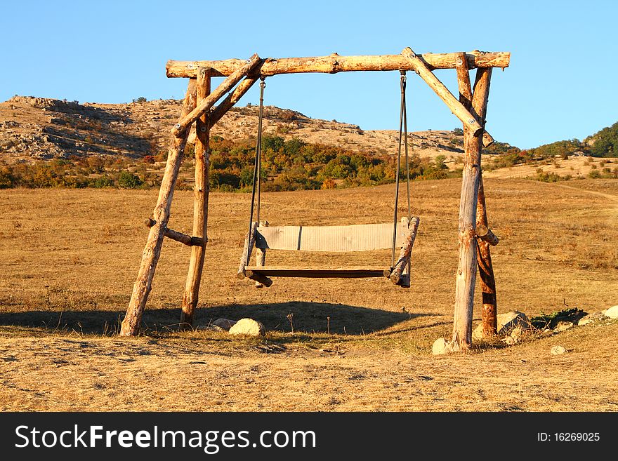 Wooden swing in the mountains